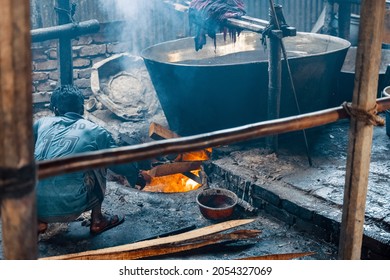 DHAKA, BANGLADESH - OCTOBER 03, 2021: Underaged Workers Or Child Labour In The Textile Industry Where They Are Dying The Garments And Textiles By Hand In A Bath Full Of Dying Chemicals 