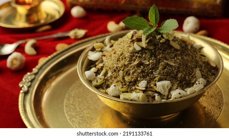 Dhaniya Panjeeri topped with Tulsi Leave (Holy Basil) is served in Authentic brass bowl on the occasion of Janmashtami Festival. (Gopal Ashtami food Concept) - Shutterstock ID 2191133761