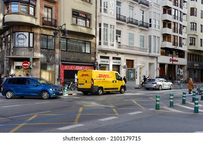 DHL Express Delivery Car On Street In City. DHL Mail Delivery Vehicle. The DHL Development E-commerce. December 16, 2021, Spain, Valencia.