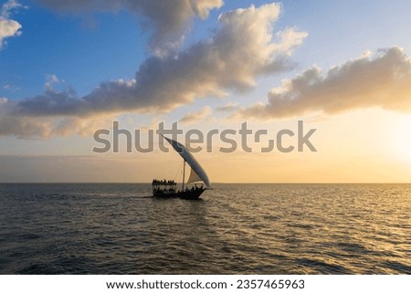 Dhow boat at sunset, background clouds, Zanzibar in Tanzania.
