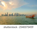 Dhow near West bay sky scrapers is an iconic water taxi. Traditional boat made from wood.Located at Doha corniche. A fishing or pearl boat in the past. A heritage for Qatar.