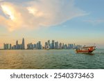 Dhow near West bay sky scrapers is an iconic water taxi. Traditional boat made from wood.Located at Doha corniche. A fishing or pearl boat in the past. A heritage for Qatar.