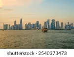 Dhow near West bay sky scrapers is an iconic water taxi. Traditional boat made from wood.Located at Doha corniche. A fishing or pearl boat in the past. A heritage for Qatar.