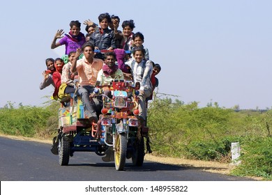 DHRANGADHRA, INDIA - MARCH 14: Unidentified travellers, mostly salt workers in the Little Rann of Kutch on March 14, 2012 near Dhrangadhra, Gujarat, India. Transport for workers is often overcrowded.