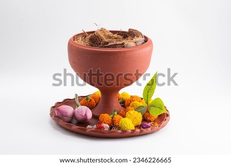 DHUNUCHI WITH CLAY THALI. COLOURFUL FLOWER AND COCONUT HUSK ISOLATED ON WHITE BACKGROUND.SELECTIVE FOCUS.