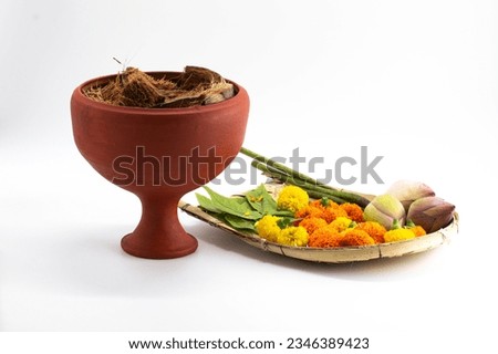 DHUNUCHI WITH KULO WITH COLOUFUL FLOWER ISOLATED ON WHITE BACKGROUND.SELECTIVE FOCUS WITH GRAINY TONE.