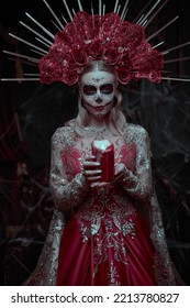 Dia De Los Muertos. Santa Muerte. Gorgeous Calavera Catrina In A Festive Rich Dress And Headdress Stands In The Castle With A Candle In Her Hand. Sugar Skull Girl. Day Of The Dead. Halloween.