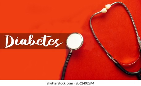 Diabetes concept with black stethoscope on red background