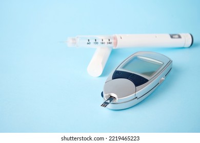 Diabetes Equipment Glucometer, Insulin Syringe, Injection Pen. Diabetes Disease Concept, Blue Background With Copy Space