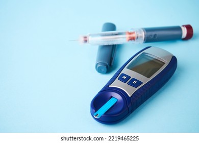 Diabetes Equipment Glucometer, Insulin Syringe, Injection Pen. Diabetes Disease Concept, Blue Background With Copy Space