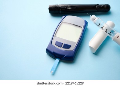 Diabetes Equipment Glucometer, Insulin Syringe, Injection Pen. Diabetes Disease Concept, Blue Background With Copy Space