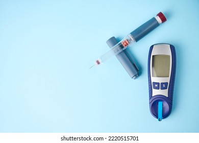 Diabetes Equipment Glucometer, Insulin Syringe, Injection Pen. Diabetes Disease Concept, Blue Background With Copy Space