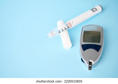 Diabetes Equipment Glucometer, Insulin Syringe, Injection Pen. Diabetes Disease Concept, Blue Background With Copy Space