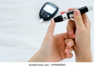 Diabetes And Glycemia. Blood Sugar Testing, Child Finger Lancet Punctures.