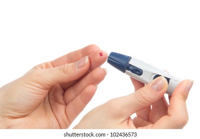 Diabetes lancet in hand prick finger to make punctures to obtain small blood specimens for blood glucose, hemoglobin level test using glucometer isolated on a white background