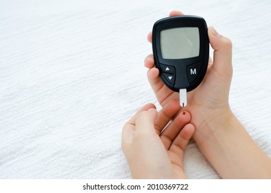 Diabetes Test. Child Hands Checking Blood Sugar Level By Glucose Meter.