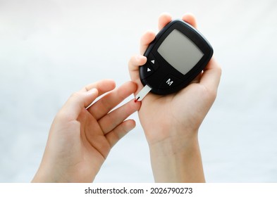 Diabetes Test. Child Hands Checking Blood Sugar Level By Glucose Meter.