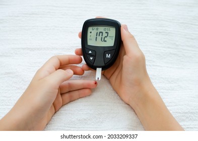 Diabetes Test. Child Hands Checking Blood Sugar Level By Glucose Meter.