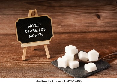 “World Diabetes Month” wordings on a chalkboard with sugar cubes. November is the world diabetes month