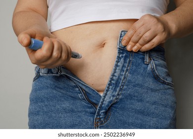 Diabetic patient using insulin pen for making an insulin injection at home. Woman control diabetes. Diabetic lifestyle - Powered by Shutterstock