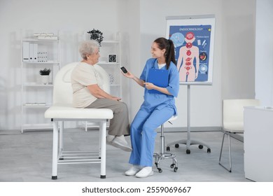 Diabetic senior woman and doctor with glucometer in clinic - Powered by Shutterstock