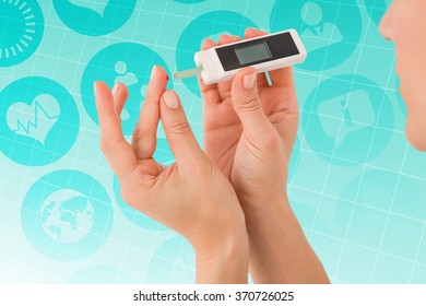 Diabetic Woman Using Blood Glucose Monitor Against Ecg Line On Blue Grid