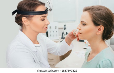 Diagnosis and treatment of nasal disease. ENT doctor examines nose of female patient with a medical tool. Sinusitis treatment