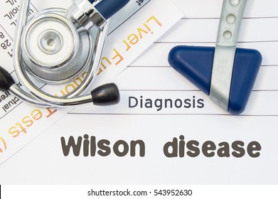 Diagnosis Wilson Disease. Neurological Hammer, Stethoscope And Liver Laboratory Test Lie On Note With Title Of Wilson Disease. Concept For Neurology And Gastroenterology