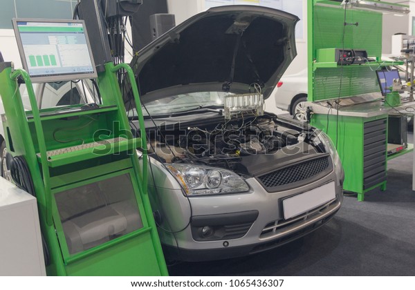 Diagnostic\
equipment and a car in a car service.\
Industry