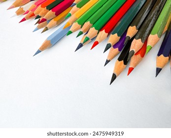 Diagonal arrangement of sharp multi colored pencils on white background with empty space for text. Artistic concept for stationery, education, design advertising banner for school products. - Powered by Shutterstock