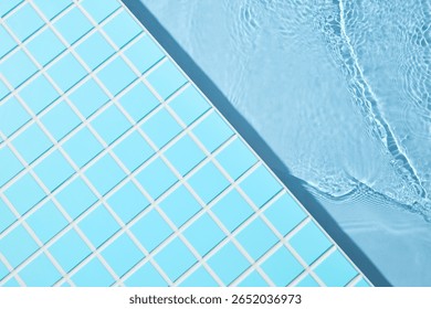 Diagonal composition of sharp pool lines where mosaic tiles meet crystal-clear water. A minimalist architectural balance perfect for high-end mockups and skincare branding with tropical energy.