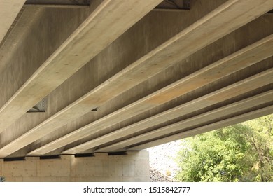 Diagonal concrete beams with a slanted view creating an interesting artistic concept.