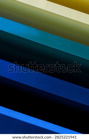 Diagonal gradient colour bands on a painted surface, gold fading through teal to blue, Fortitude Valley Brisbane