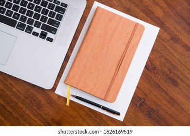 Diagonal Layflat Of Workspace. Self Starter, Meeting Minutes, Note Taking And Working As A Student Or At A Cafe/ Coffee Shop On Wooden Table With Cup Of Coffee/tea. Mobile Office, Work Anywhere