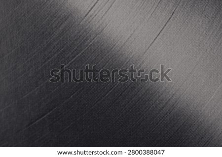 Diagonal Light Reflection on Black Vinyl Record Surface Close Up Abstract Texture