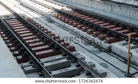 diagonal mass rapid transit (MRT) rail track on asphalt