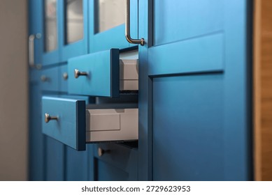 Diagonal side view highlights deep blue fronts and inner drawers with smooth lines. Smart storage cleanliving concept for modern interior trends and homedecor visuals.