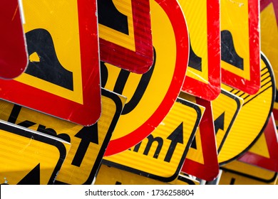 Diagonal Stack Pile Of Roadwork Construction Maintenance Traffic Road Signs Yellow Red Black Metric