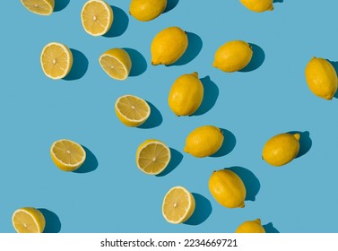 Diagonal summer pattern made with fresh yellow and lemon slices on bright blue pastel background. Minimal background summer concept on bright sunlight with sharp shadows - Shutterstock ID 2234669721