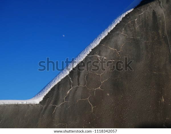 diagonal wall with snow\
and moon. flat lay