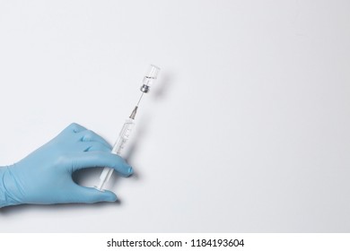 dial the medication into a syringe from the ampoule isolated on white background - Shutterstock ID 1184193604
