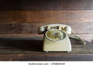 Dialing Or Scrolling Phone On Wooden Table