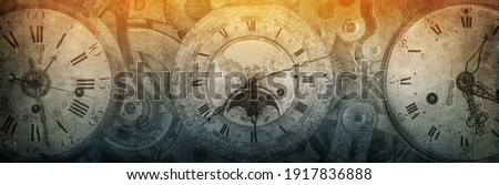 The dials of the old antique classic clocks on a vintage wide paper background. Concept of time, history, science, memory, information. Retro style. Vintage clockwork background.