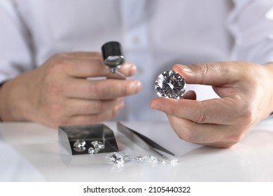 Diamond Dealer Evaluates Large Round Cut Diamond At Workplace In Jewellery Exhibition.