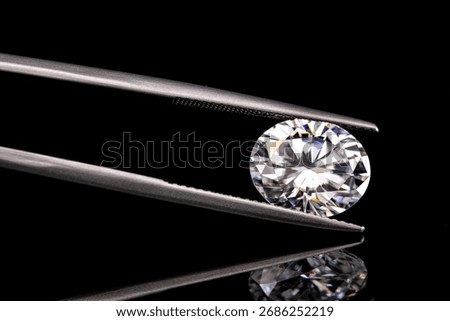 A diamond is displayed in a diamond setting. The diamond is cut in the shape of an oval