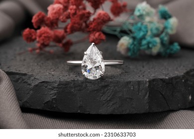 Diamond engagement ring isolated on black stone, Diamond ring for girls  - Shutterstock ID 2310633703