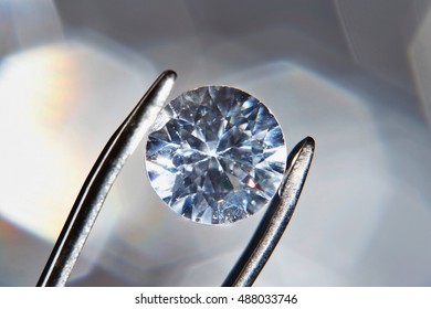 Diamond held by tweezers, close-up