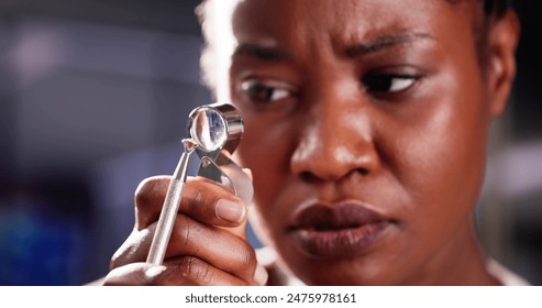 Diamond Inspector Examining Quality Through Magnifying Loupe in African-American Jeweler's Shop. Woman Assessing Gemstone Value With Precision Tools. - Powered by Shutterstock