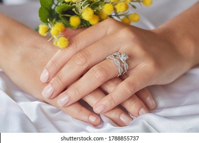 Diamond Jewellery. Diamond Rings On Woman Finger And Flowers