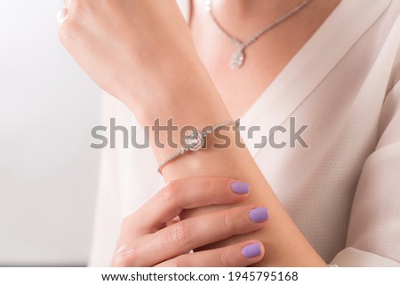Diamond jewelry. Diamond bracelet on young lady.